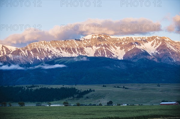 Mountains over farmlands in rural landscape