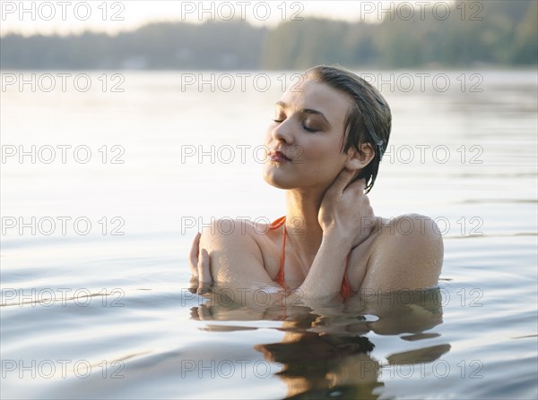 Caucasian woman swimming in still lake