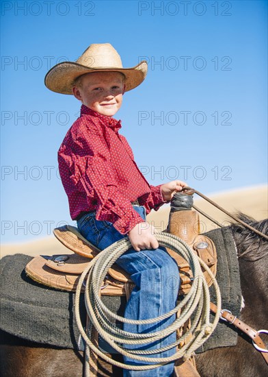 Caucasian boy riding horse