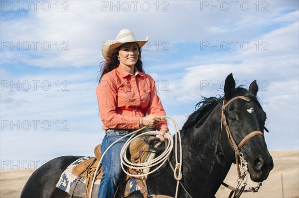 Caucasian woman smiling on horse