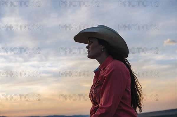 Caucasian woman under sunset sky