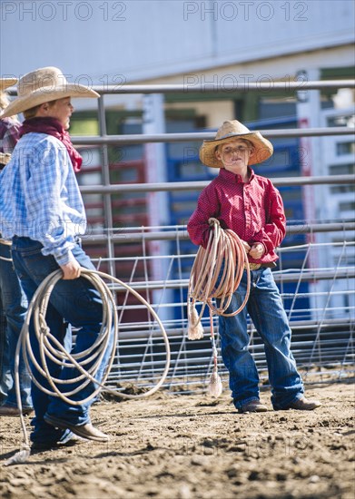 Caucasian cowboys holding lasso rope