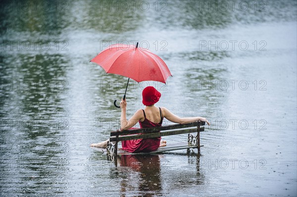 Caucasian woman sitting on bench in flood