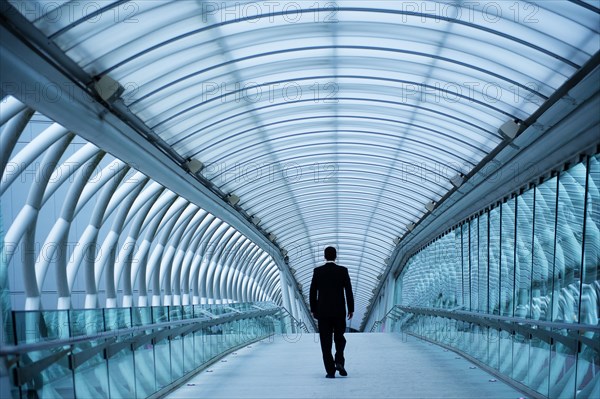 Caucasian businessman walking in tunnel