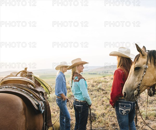 Cowgirls with horses on ranch