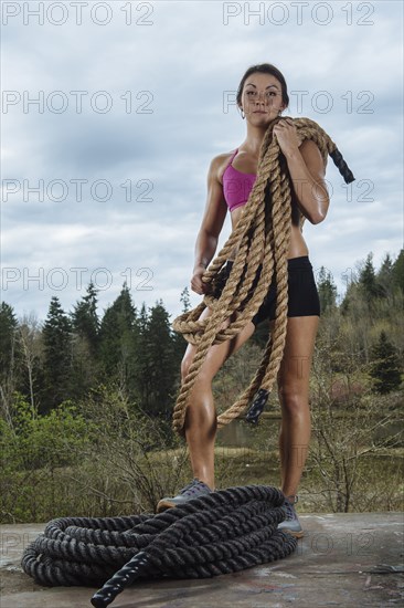 Mixed Race posing with heavy ropes