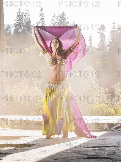 Belly dancer holding purple fabric
