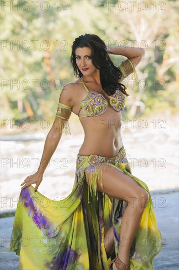 Belly dancer posing holding skirt