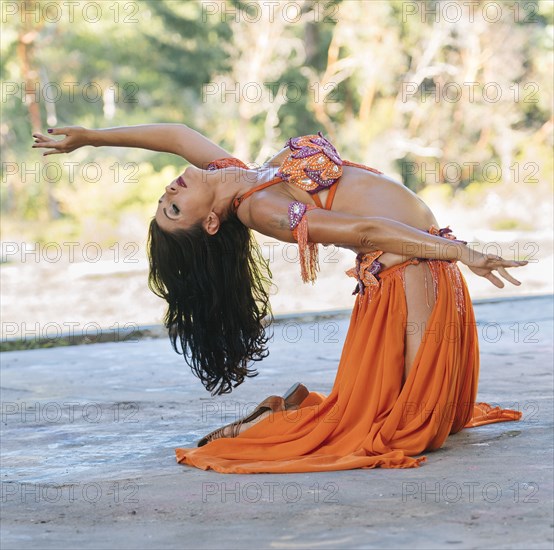 Belly dancer kneeling on stage