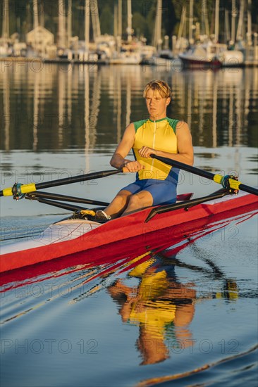 Caucasian man rowing on lake