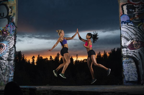 Runners jumping and high-fiving