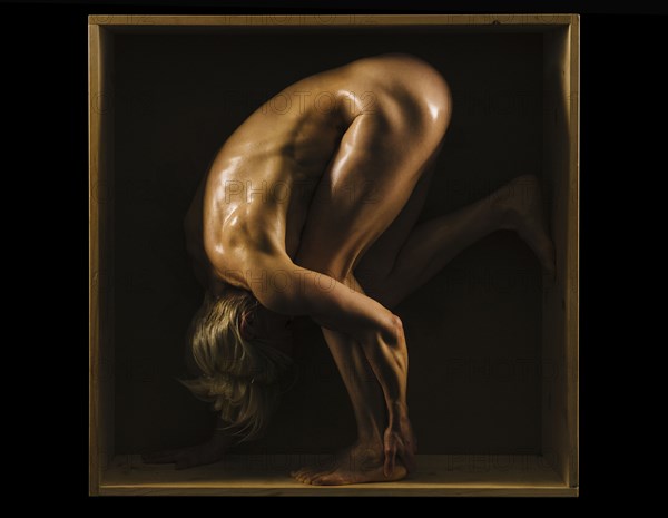 Muscular Caucasian woman bending in box