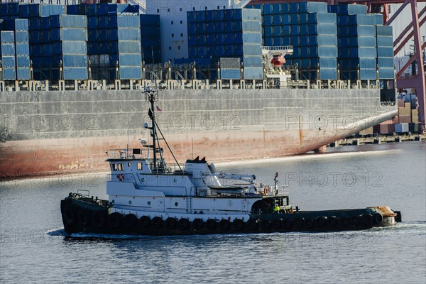 Tugboat in harbor at shipping port