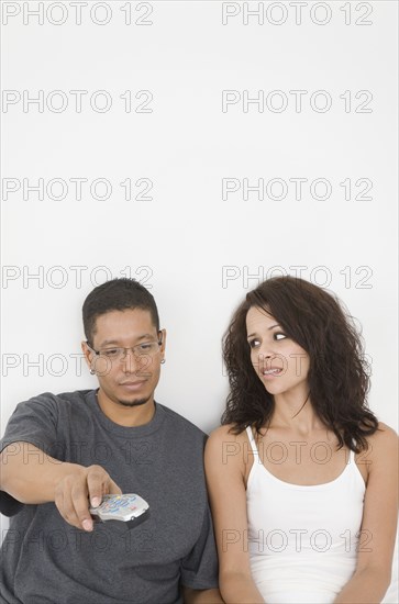 Hispanic couple watching television