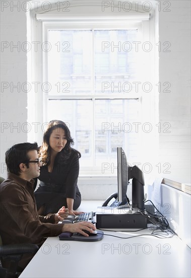 Multi-ethnic businesspeople looking at computer