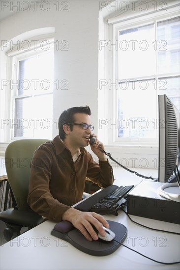 Hispanic businessman talking on telephone