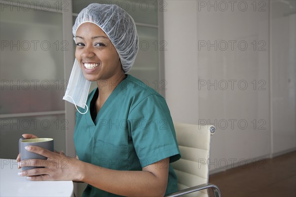 Smiling surgeon drinking coffee