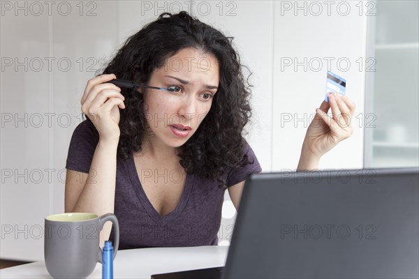 Hispanic woman putting on make up