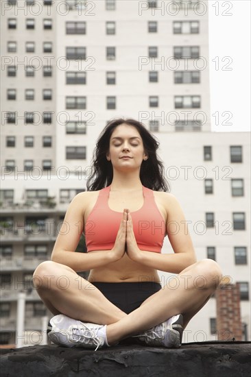 Woman practicing yoga on rooftop