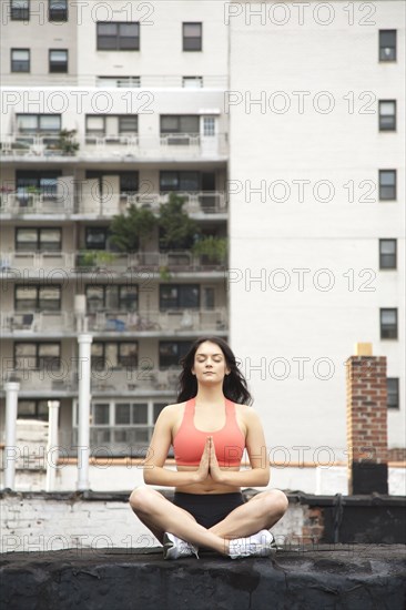 Woman practicing yoga on rooftop