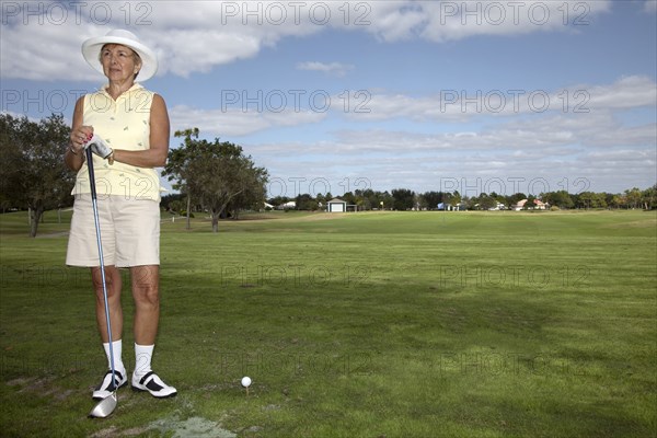 Senior Caucasian woman playing golf