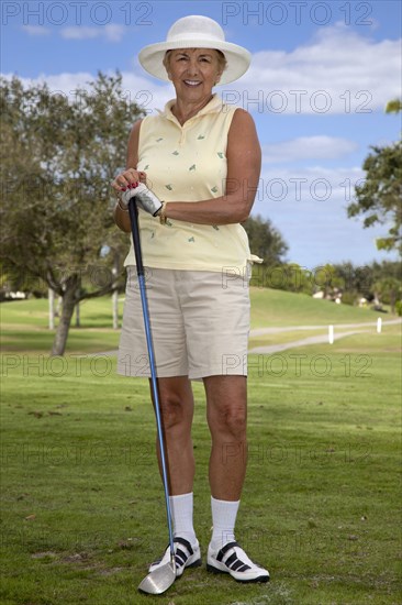 Senior Caucasian woman playing golf