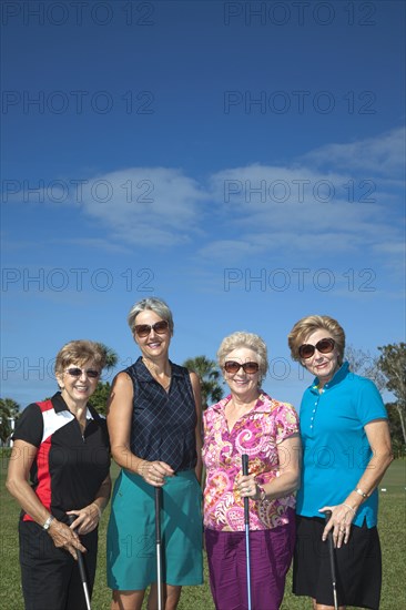 Senior Caucasian women playing golf