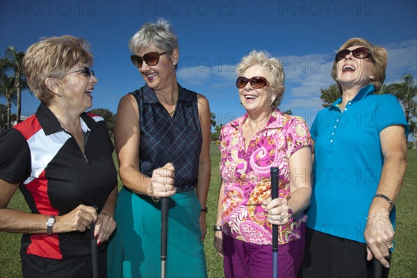 Senior Caucasian women playing golf