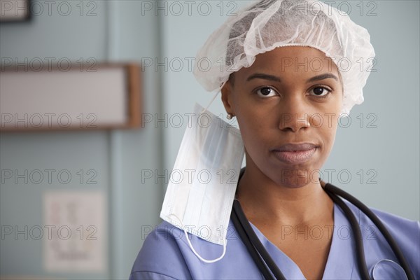 Black surgeon in surgical cap and mask