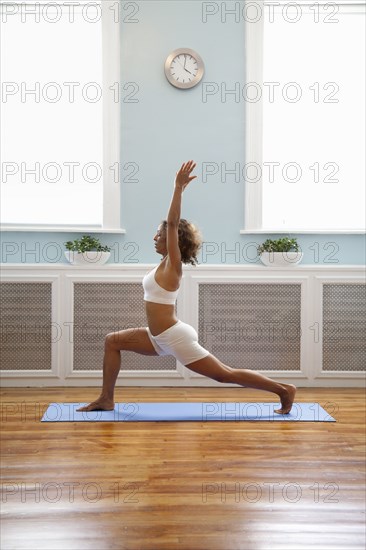 Mixed race woman practicing yoga