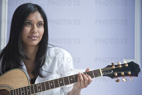 Sri Lankan woman playing guitar