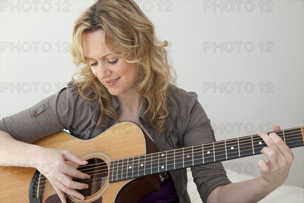 Caucasian woman playing guitar