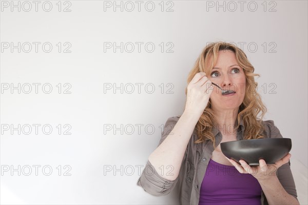 Caucasian woman eating soup