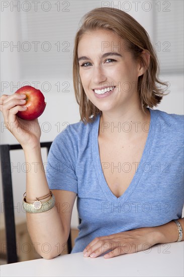 Caucasian woman eating an apple