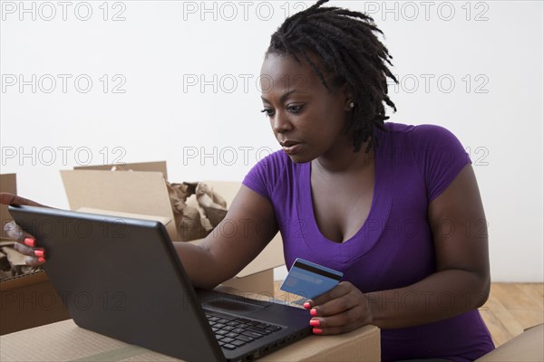 Black woman shopping online with credit card