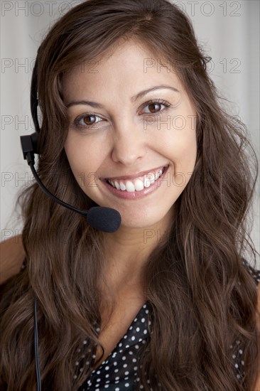 Mixed race businesswoman wearing headset