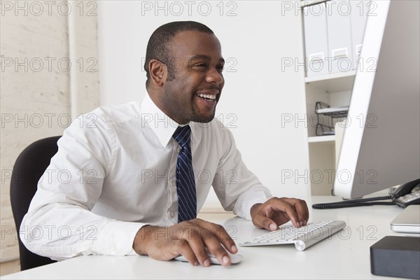 Black businessman using computer at desk