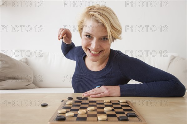 Caucasian woman playing checkers