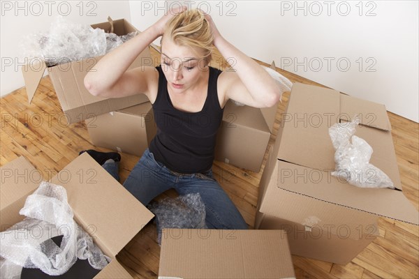 Caucasian woman unpacking boxes in new home