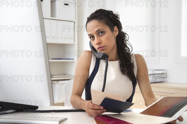 Hispanic businesswoman talking on phone