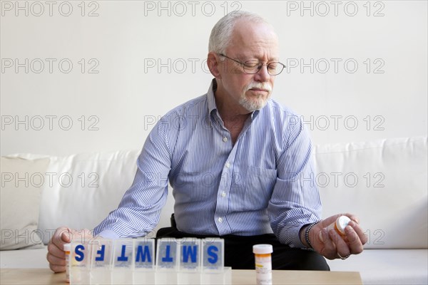 Caucasian man taking pills