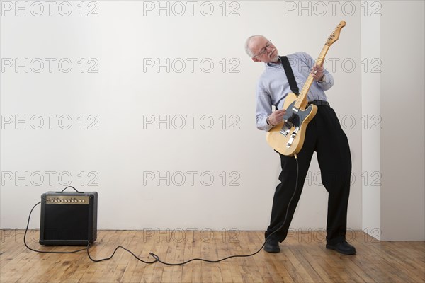 Caucasian man playing electric guitar