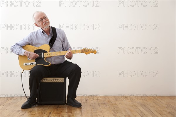 Caucasian man playing electric guitar