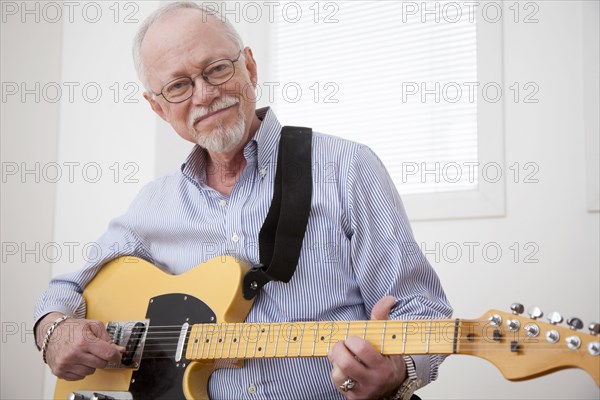 Caucasian man playing electric guitar