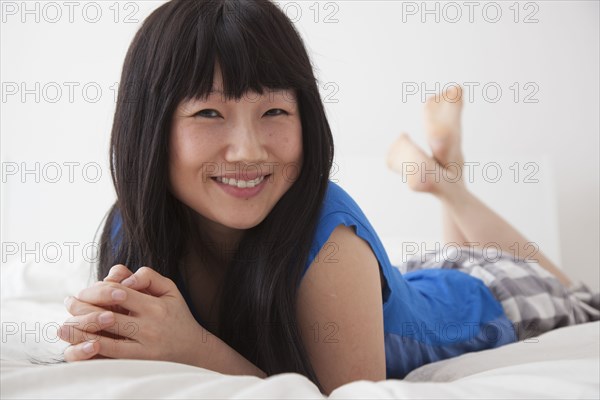 Chinese woman laying on bed