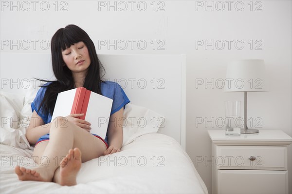 Chinese woman sleeping with book in hand