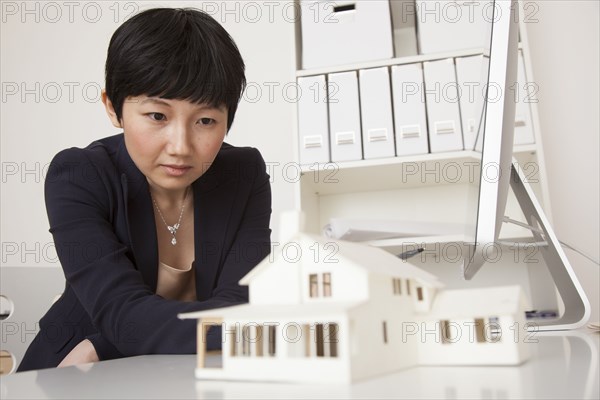 Businesswoman working on model in office