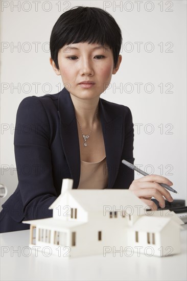 Businesswoman working on model in office