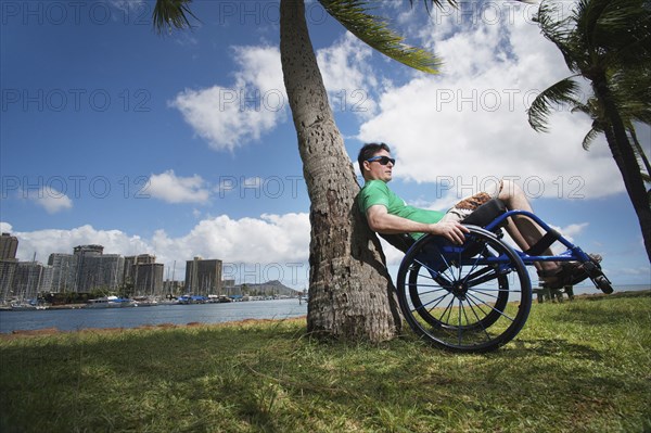 Disabled man playing in wheelchair on beach