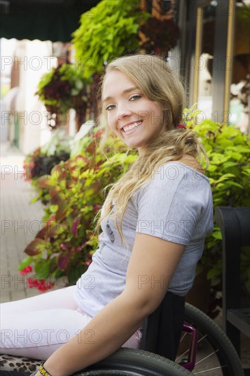 Disabled Caucasian girl smiling in wheelchair